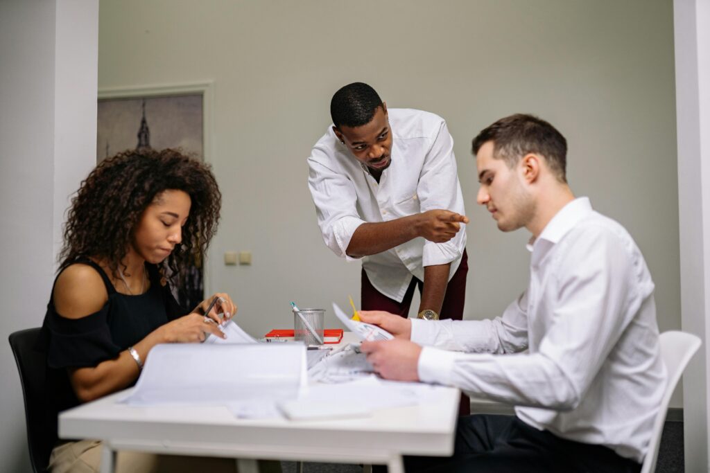 Three people collaborating in the office.