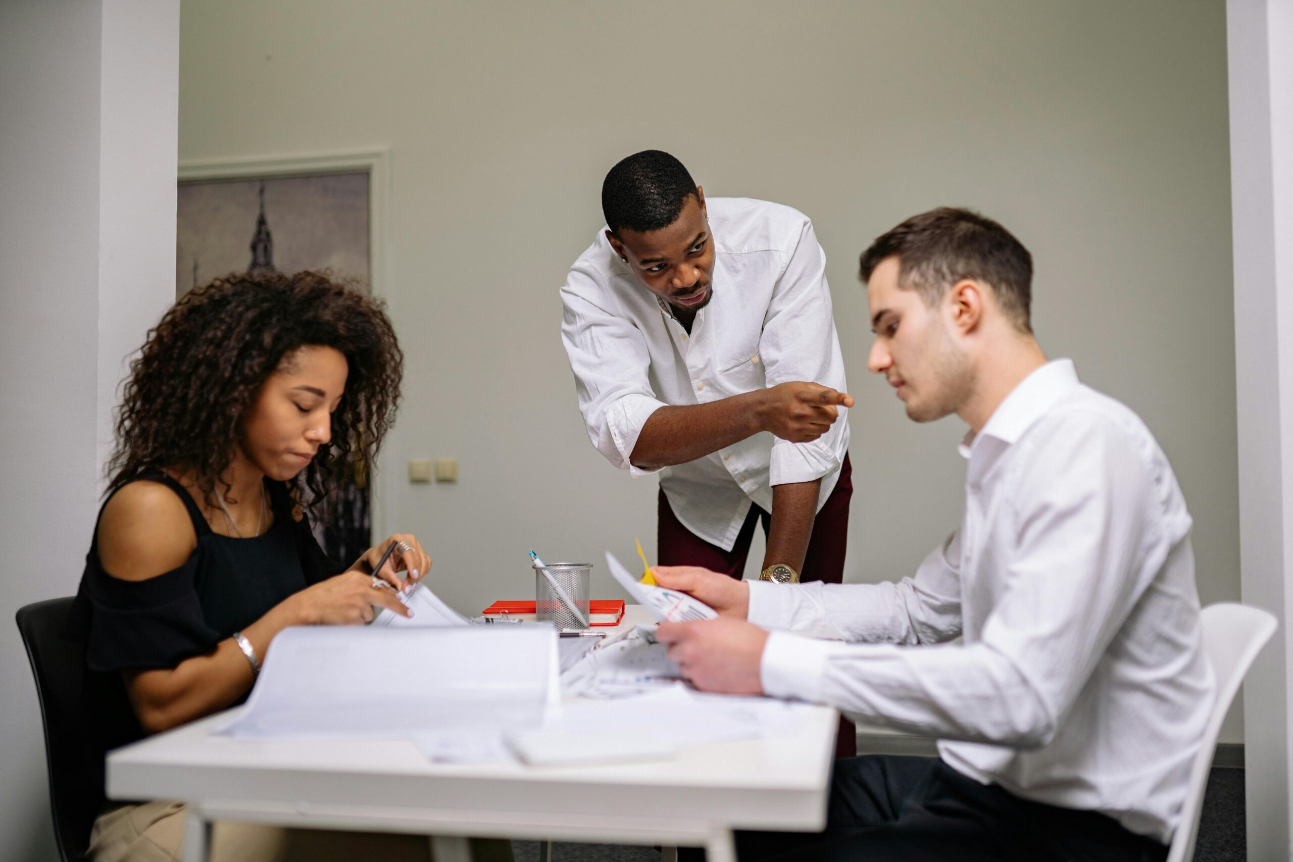 Three people collaborating in the office.